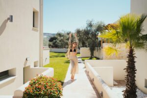 woman outside stretching arms