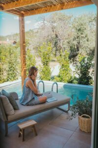 woman sitting on outside sofa reading a magazine