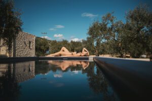 woman lying on the side of pool